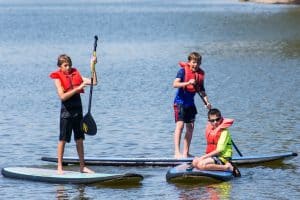 a picture of youth stand up paddle board